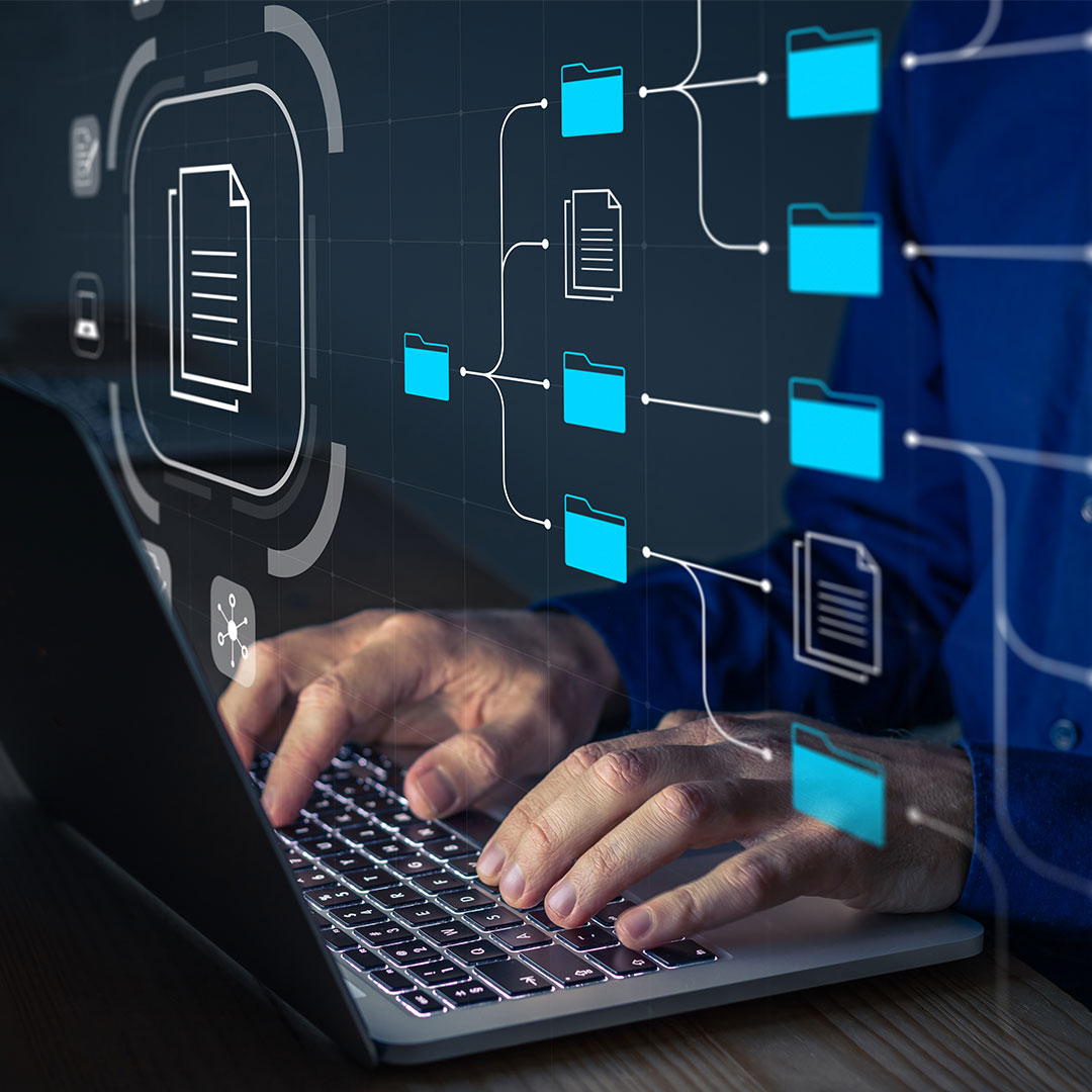 OSS consultants man typing at computer with file folder structure overlay over the image